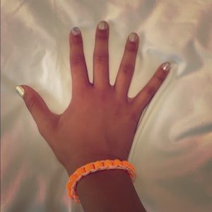 A bracelet with orange and white colors